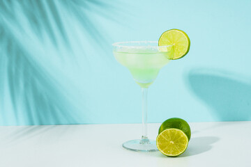 Margarita cocktail. Summer alcohol drink on blue background.