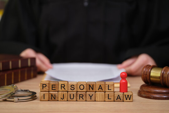 A judge sits at a desk, surrounded by legal tools and documents, engaged in a thoughtful discussion about personal injury law. The atmosphere is serious and focused.