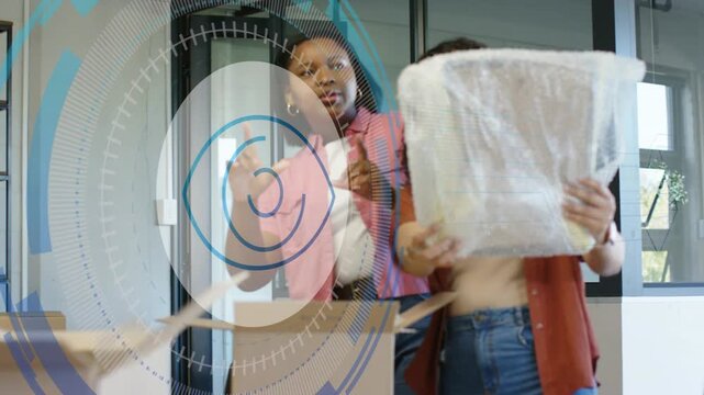 Box opening causing woman lifting bubble wrap item, office team inspecting while HUD guiding setup