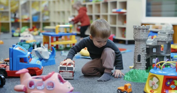A boy plays with toys at the kids club