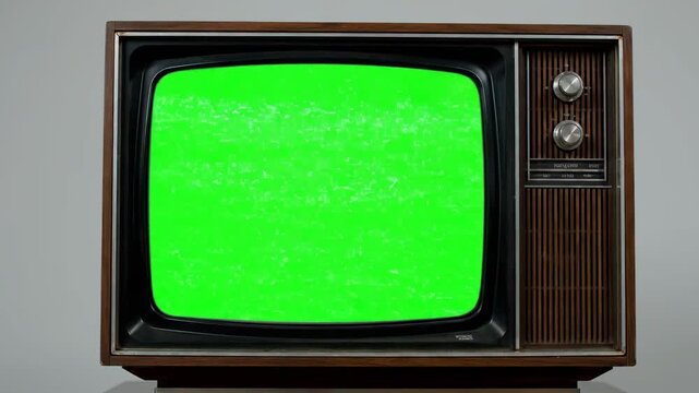 Classic retro television with a green screen and static interference, ideal for overlaying custom content on a nostalgic vintage display.
