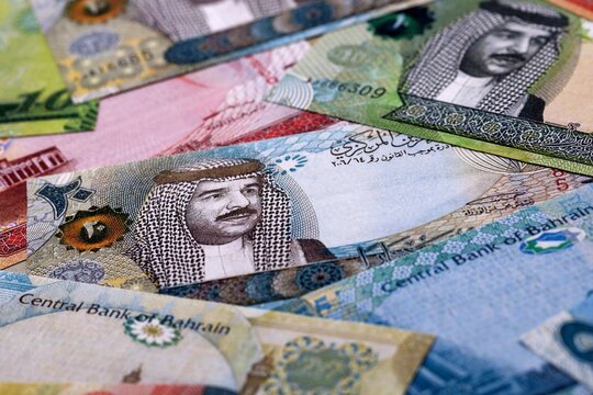 Bahraini dinar money bills pile on table. Bahrain banknotes of BHD currency close up.