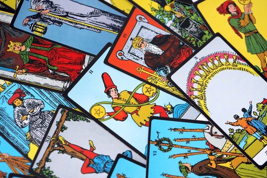 Big pile of different classical tarot cards on table. Pattern of tarot cards with traditional standard meanings
