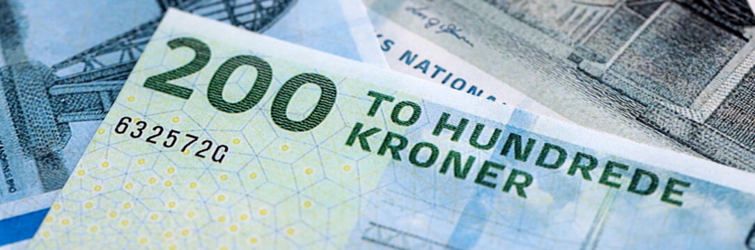 Danish krone paper banknotes pile on table. Denmark DKK currency money bills in big amount. Concept of economics, taxation and banking in Denmark