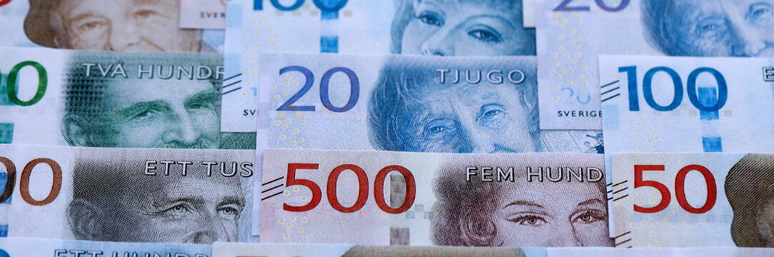 Swedish krona paper banknotes pile on table. Sweden SEK currency money bills in big amount. Concept of economics, taxation and banking in Sweden