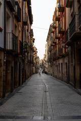 Fototapeta premium Narrow cobblestone street with traditional balconies in the historic old town of Logroño, Spain