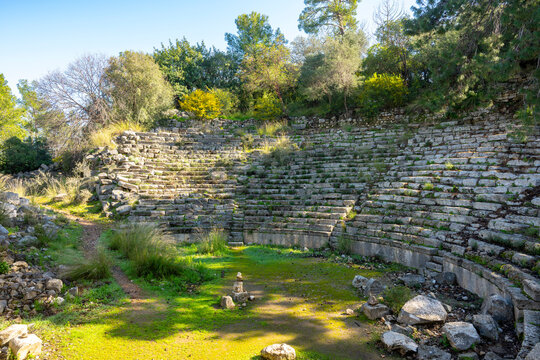 Phaselis ruined building with a tree growing through it near the coast.  Phaselis antic archeologic site in Turkey Kemer Antalya.The ancient site of Phaselis lies 58 km south of Antalya on an isthmus 