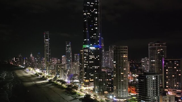 Tallest building, skyscraper in Gold Coast, Queensland. Night skyline, modern downtown. Crane shot