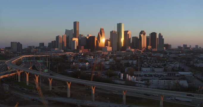 Drone Footage of Downtown Houston Skyline Illuminated at during sunset