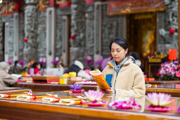 Fototapeta premium Woman performing ritual inside temple hall