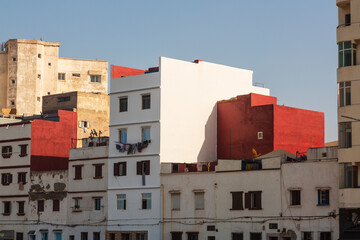 Facade of residential buildings with drying clothes and carpets inside Medina in Casablanca, Morocco
