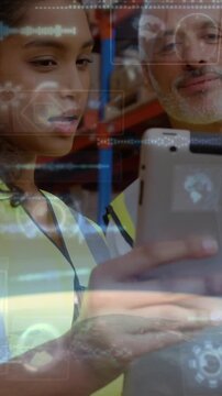 Vertical video: Male tapping scanner and female bringing tablet in warehouse HUD showing inventory