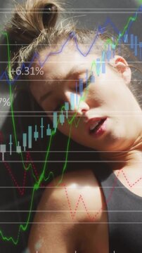 Vertical video: Woman panting on mat market charts appearing glove settling by head eyes opening