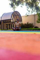 Woman relaxing on colorful rainbow diversity path