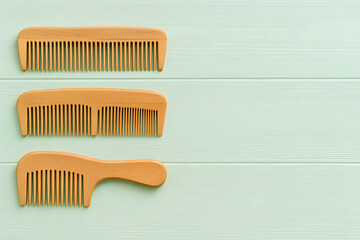 Wooden hair comb set on green background natural grooming accessory eco friendly beauty product sustainable lifestyle minimal design banner background