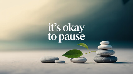 Obraz premium Stacked Zen Stones and a Green Leaf with Text it's okay to pause on a soft focus background Keywords: zen, stones