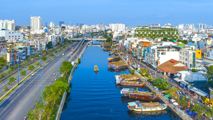 Fototapeta premium Aerial view of floating flower market in Saigon or Ho Chi Minh City in Vietnam. The market on the Canal is open for the Tet Holiday or Lunar New Year