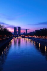 Obraz premium city river at twilight with three distant towers, illuminated promenade and purple pink sky reflecting on calm water, peaceful and tranquil evening atmosphere