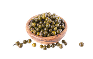 Pickled green peppercorns isolated on white background. Marinated unripe drupes of the Piper nigrum vine in wooden bowl. Clipping path.