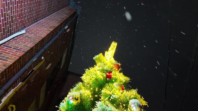 Snow covered Christmas tree view from bottom to top. Snowy winter streets