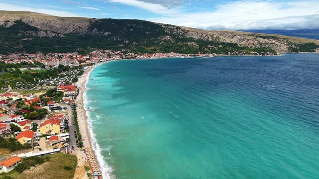 Aerial panoramic view of Ba&scaron;ka town on Krk island, Croatia, with turquoise Adriatic Sea. Concept of summer travel, seaside vacation and European coastal tourism