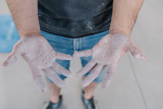 Close-up of athlete with chalk in hands