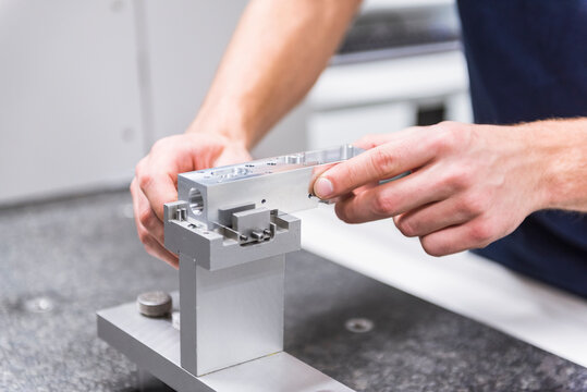 Close-up of a man at a machine in testing instrument room