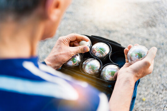 Senior man with boules ball kit
