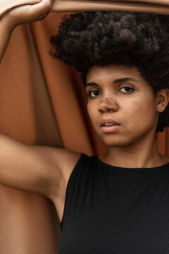 Portrait of young woman holding blanket