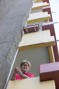 Senior woman on balcony, retirement home