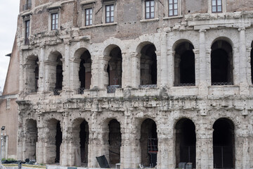 Naklejka premium Historic Teatro di Marcello in Rome featuring ancient stone arches and classical Roman architecture landmark.