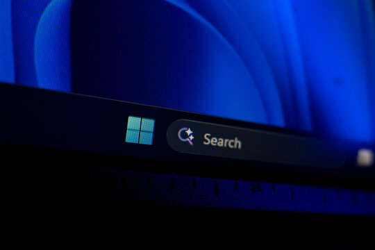 Windows 11 taskbar showing the Start button and search bar against a dark blue background, modern desktop operating system navigation and user interface concept