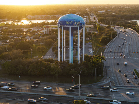 Aerial view of the water tower with the city's emblem standing tall as traffic flows along the highway, Sunrise, Florida, United States.