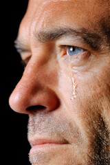 Fototapeta premium Men expressing deep emotion with a tear falling softly