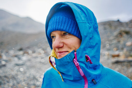 Argentina, Patagonia, El Chalten, portrait of woman in raincoat at Cerro Torre in Los Glaciares National park