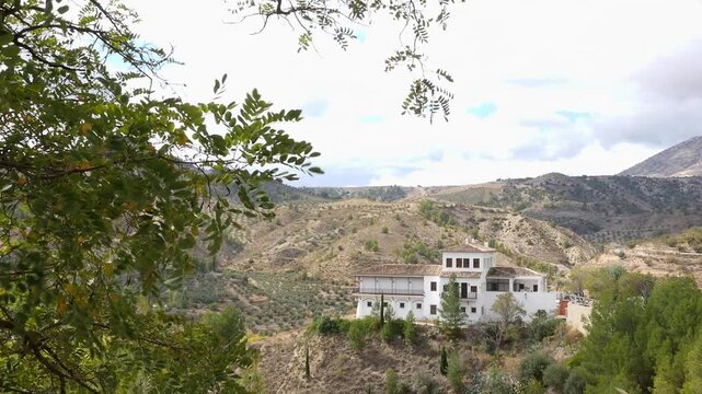 General view of the Sierra de Castril Visitor Center. Natural light on the Mediterranean mountains and olive groves. Rural tourism, Spanish architecture, and nature conservation.