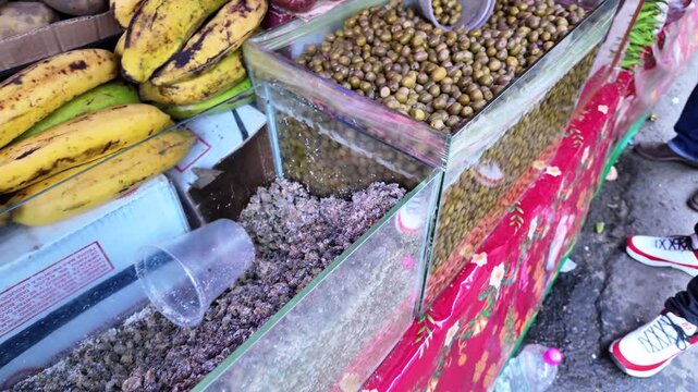 Market stall selling hallacas ingredients olives and capers in streets