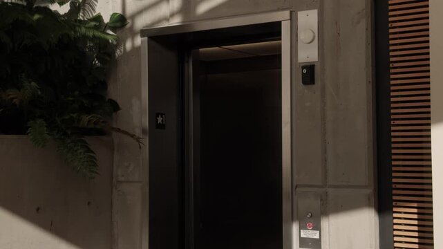 Floaty steady shot of elevator doors closing in lobby