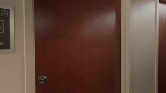 Steady left to right glide past restroom entrance