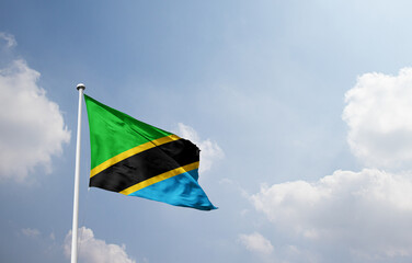Tanzania national flag waving in sky.