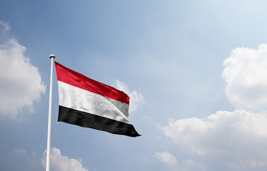 Yemen national flag waving in sky. © Muhammad Arif
