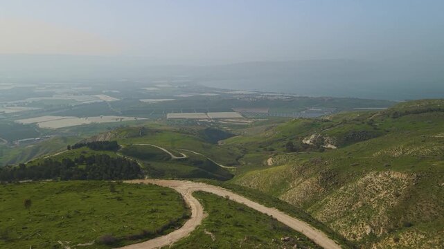 Sea of Galilee landscape in Israel is framed by the fast-moving view over Mevo Hama forest.