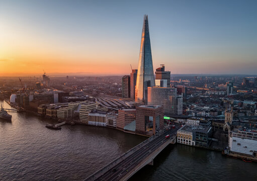 London, England - February 28th 2026: aerial sunrise view of the Shard building and London Bridge in golden morning sunlight