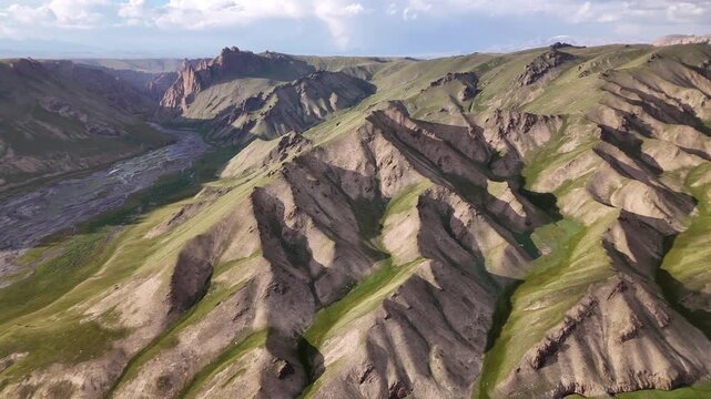 Aerial view of layered sedimentary hills in Kok-Kiya Valley, Kyrgyzstan