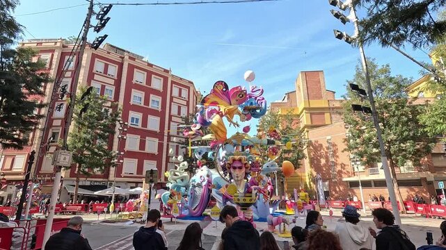 Visitors admire an elaborate and colorful ninot sculpture during Las Fallas festival in Valencia, Spain