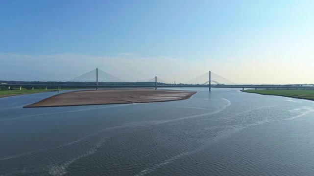 Liverpool, Merseyside, UK, June 19, 2025; Aerial 4K video footage of the Mersey Gateway toll bridge with stunning views over the River Mersey, Liverpool, UK.