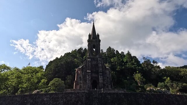 Neo-Gothic Capela de Nossa Senhora das VitĂ&Acirc;łrias near Lagoa das Furnas, Sao Miguel Island, Azores, under dramatic clouds