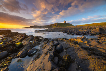 Dunstanburgh Castle on a beautiful summer morning, Northumberland, England, UK.