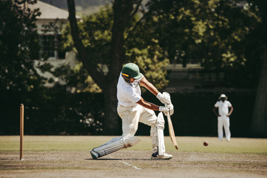 Batter stepping forward to meet the ball