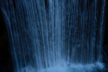 Serene Waterfall Flowing Through Lush Forest - Nature Backdrop